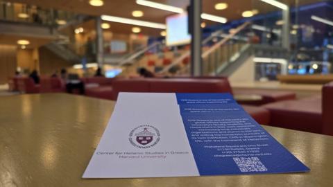 A few Harvard CHS Greece brochures rest on a table in the warm, modern lounge of the Smith Campus Center Commons.