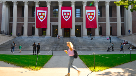  Students come and go before grand pillars and scarlet banners of Harvard’s Widener Library.
