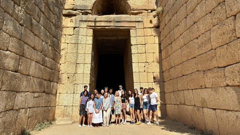 Harvard Summer School students in front of the Treasury of Atreus at Mycenae during an educational visit.