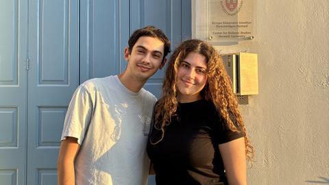 The two scholarship recipients standing outside the Center for Hellenic Studies in the evening light.