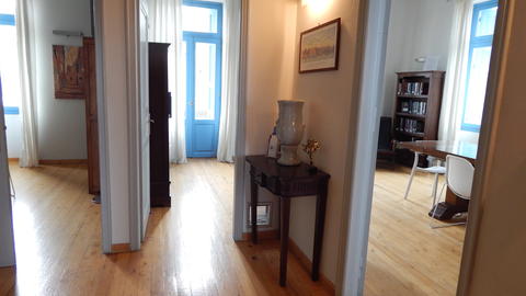 Three open entrances through rooms with wooden floors