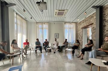 Participants seated in a circle in the CHS Greece lecture hall for the discussion following a session.