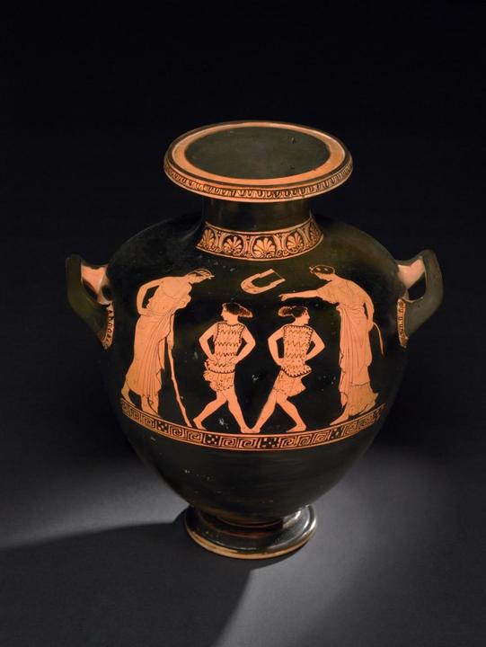 Α picture of red-figured hydria pottery depicting girls dancing, attended by an “instructress” and a youth