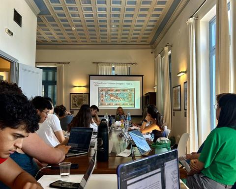 The group during class in an oval-shaped arrangement in the Fellows Room at CHS Greece.