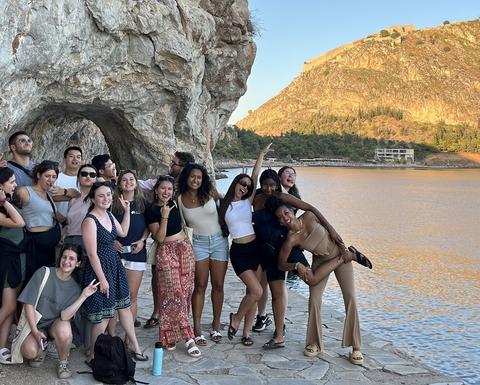 A group of people is posing for the camera in a friendly manner.